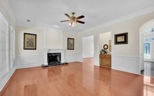 unfurnished living room with crown molding and hardwood / wood-style flooring