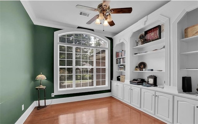 interior space featuring a healthy amount of sunlight, white cabinets, and light hardwood / wood-style flooring