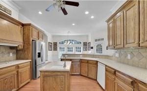 kitchen featuring light hardwood / wood-style floors, dishwasher, stainless steel fridge with ice dispenser, and a kitchen island