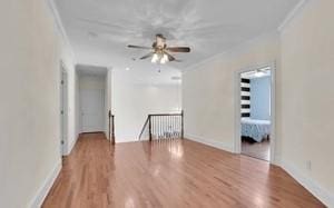 spare room with crown molding, light hardwood / wood-style flooring, and ceiling fan