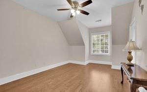 bonus room with wood-type flooring, lofted ceiling, and ceiling fan