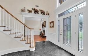 foyer featuring a towering ceiling