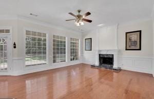 unfurnished living room with crown molding and ceiling fan