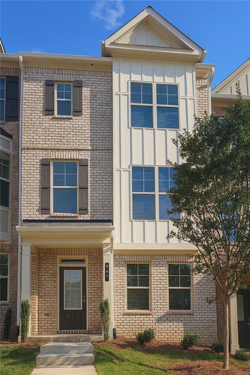 537 Fundao Ln, Lawrenceville, GA 30046 - view of front facade featuring board and batten siding and brick siding