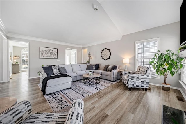 living area featuring visible vents, crown molding, baseboards, and wood finished floors