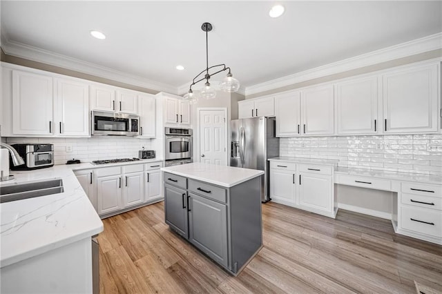 kitchen with white cabinetry, gray cabinets, appliances with stainless steel finishes, and a sink