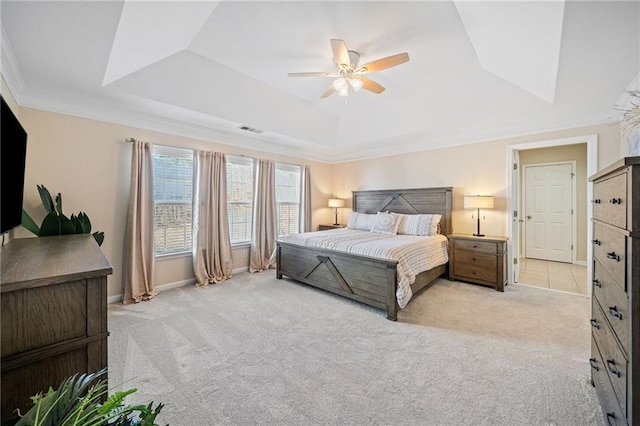 bedroom featuring visible vents, crown molding, baseboards, light carpet, and a raised ceiling