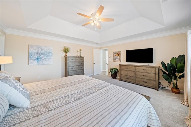 carpeted bedroom with a raised ceiling, ceiling fan, and ornamental molding