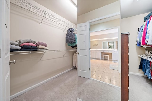 spacious closet with tile patterned floors and carpet flooring