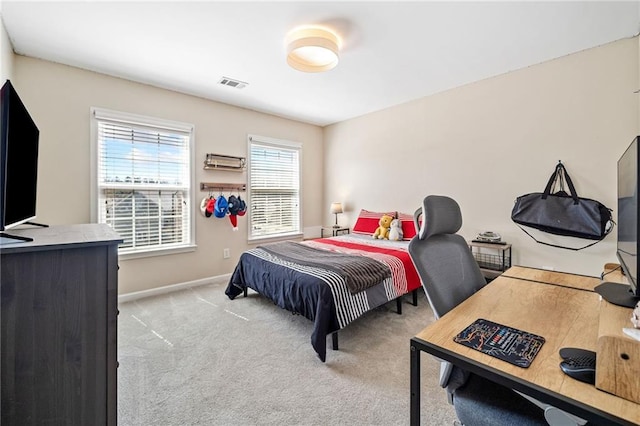 carpeted bedroom with visible vents and baseboards