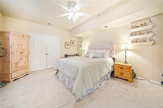 bedroom featuring visible vents, a closet, and light carpet