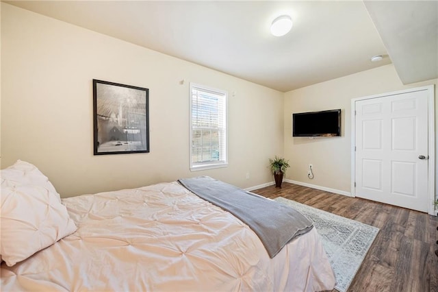 bedroom featuring baseboards and wood finished floors