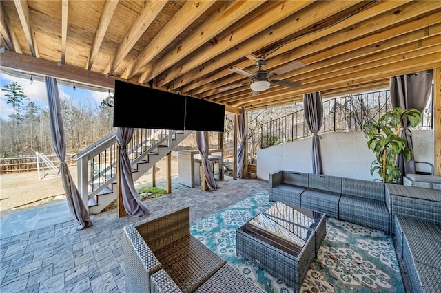 view of patio featuring outdoor lounge area, stairs, and ceiling fan