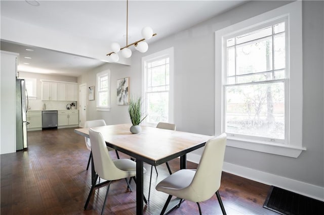 943 Rose Cir SW, Atlanta, GA 30310 - dining area with dark wood-style flooring and baseboards