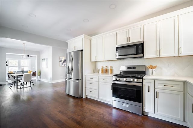 943 Rose Cir SW, Atlanta, GA 30310 - kitchen featuring stainless steel appliances, light countertops, tasteful backsplash, white cabinetry, and dark wood-style floors