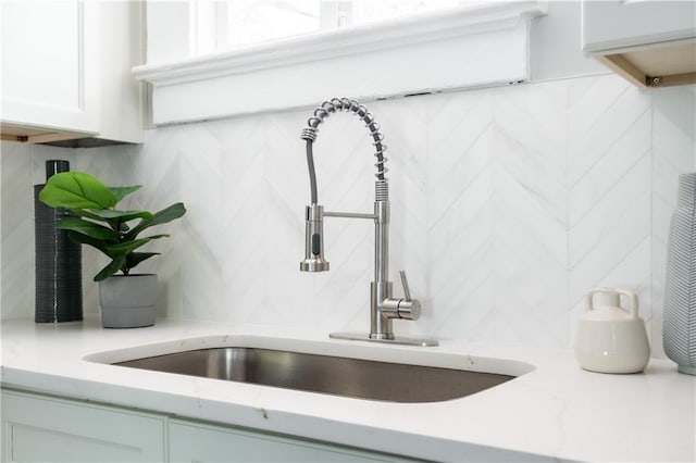 943 Rose Cir SW, Atlanta, GA 30310 - kitchen view of decorative backsplash, light stone countertops, and white cabinets