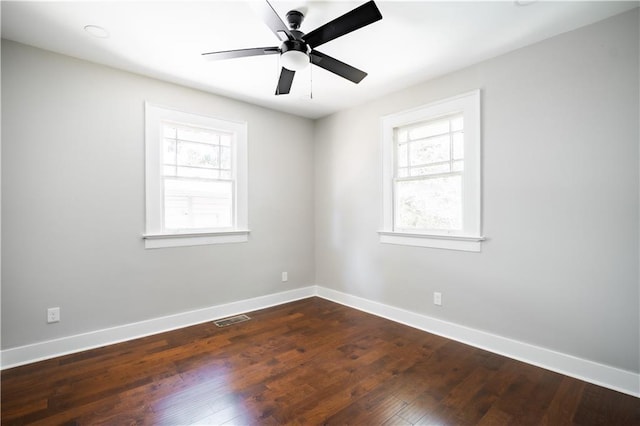 943 Rose Cir SW, Atlanta, GA 30310 - empty room with healthy amount of natural light, dark wood finished floors, and a ceiling fan