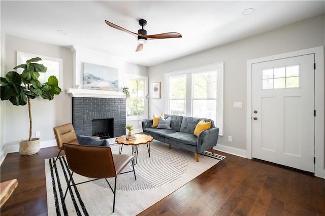 943 Rose Cir SW, Atlanta, GA 30310 - living area featuring plenty of natural light, a brick fireplace, ceiling fan, and wood finished floors
