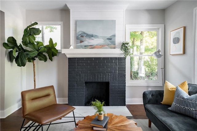 943 Rose Cir SW, Atlanta, GA 30310 - living room featuring plenty of natural light, a brick fireplace, and wood finished floors