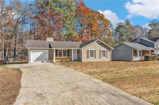 ranch-style house featuring a front lawn, a porch, and a garage