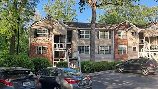 340 Teal Ct, Roswell, GA 30076 - view of building exterior featuring stairway and uncovered parking