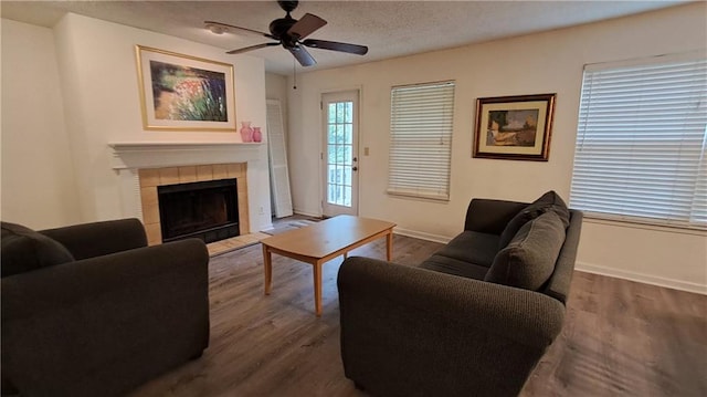 340 Teal Ct, Roswell, GA 30076 - living area featuring ceiling fan, baseboards, dark wood-type flooring, a fireplace, and a textured ceiling