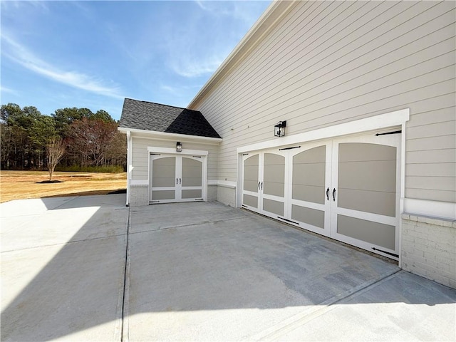 view of patio featuring a garage and concrete driveway