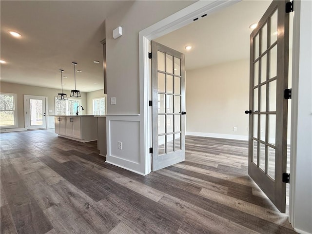 interior space with recessed lighting, french doors, dark wood finished floors, and a sink