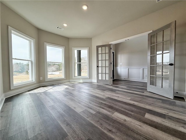 spare room featuring french doors, dark wood-style flooring, visible vents, and recessed lighting