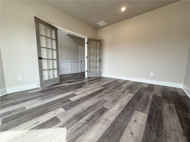 spare room featuring baseboards, visible vents, dark wood finished floors, and recessed lighting