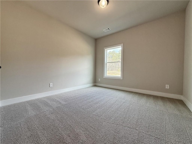 empty room with light carpet, visible vents, and baseboards