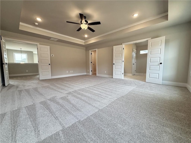 unfurnished bedroom featuring recessed lighting, a raised ceiling, visible vents, light carpet, and baseboards