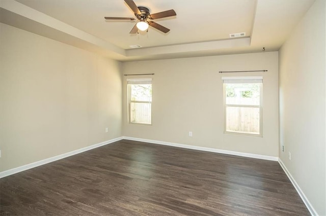 610 Sunflower Dr, Canton, GA 30114 - unfurnished room with a tray ceiling, healthy amount of natural light, dark wood-type flooring, and ceiling fan