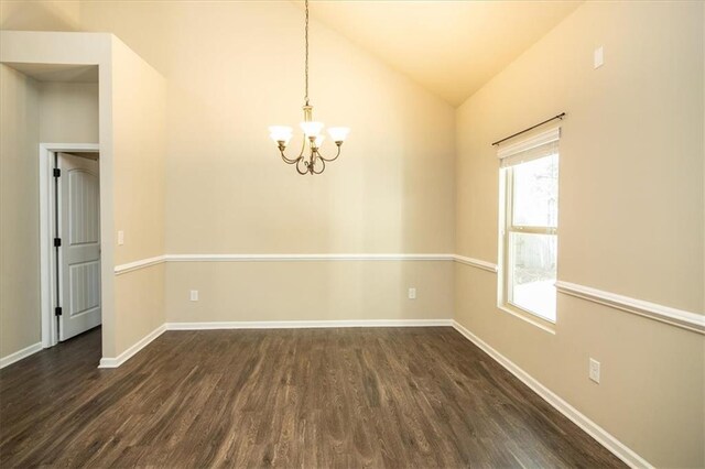 610 Sunflower Dr, Canton, GA 30114 - spare room featuring dark wood-style flooring, lofted ceiling, a chandelier, and baseboards