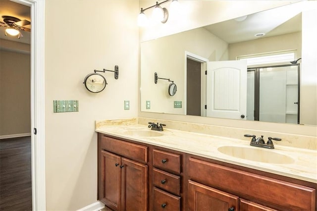610 Sunflower Dr, Canton, GA 30114 - full bathroom with double vanity, ceiling fan, an enclosed shower, and baseboards
