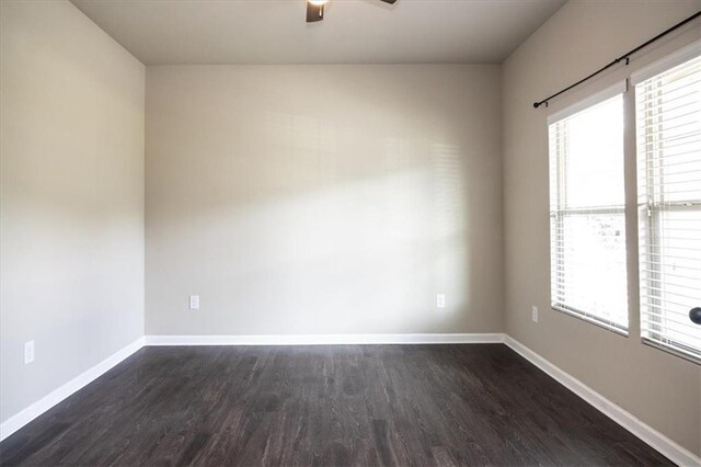 610 Sunflower Dr, Canton, GA 30114 - empty room with dark wood-style floors, baseboards, a ceiling fan, and healthy amount of natural light