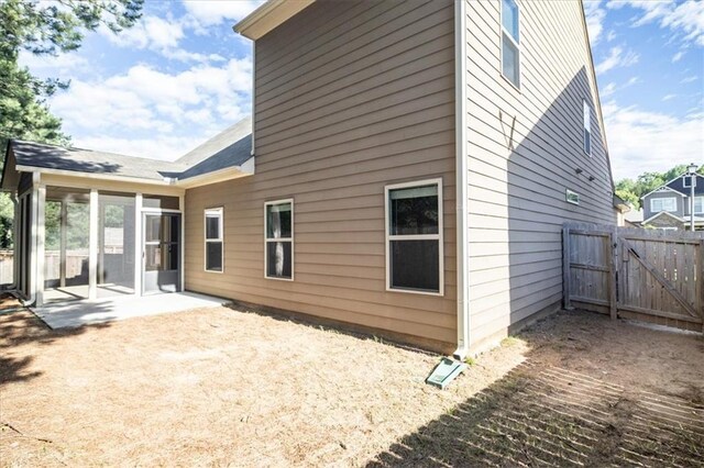 610 Sunflower Dr, Canton, GA 30114 - back of property with a sunroom, a patio area, and a gate