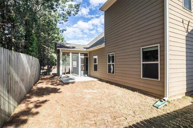 610 Sunflower Dr, Canton, GA 30114 - rear view of property featuring a patio, a sunroom, and roof with shingles