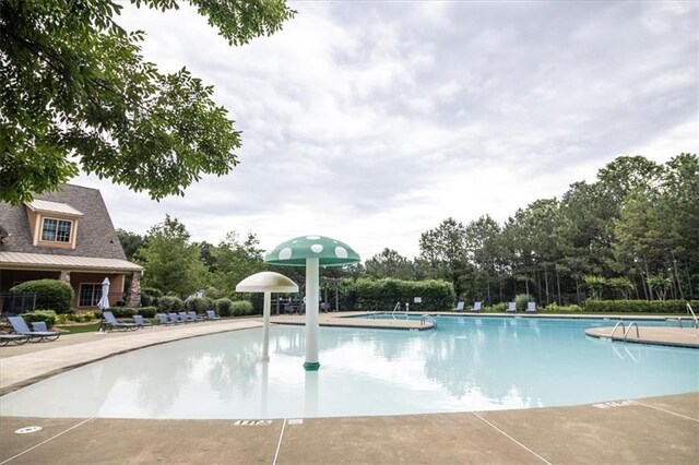 610 Sunflower Dr, Canton, GA 30114 - community pool with a patio and view of wooded area