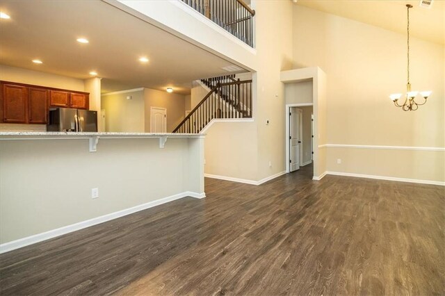 610 Sunflower Dr, Canton, GA 30114 - kitchen featuring freestanding refrigerator, a breakfast bar area, dark wood finished floors, baseboards, and recessed lighting