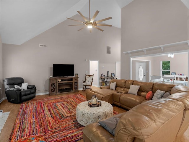 living area featuring high vaulted ceiling, ceiling fan, baseboards, and visible vents