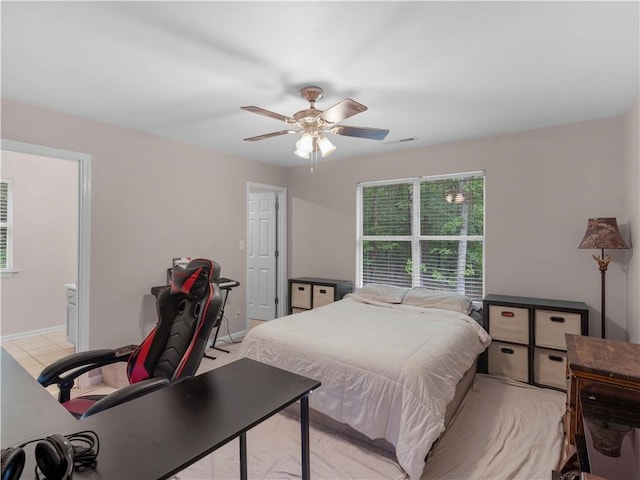 bedroom featuring baseboards, a ceiling fan, and visible vents