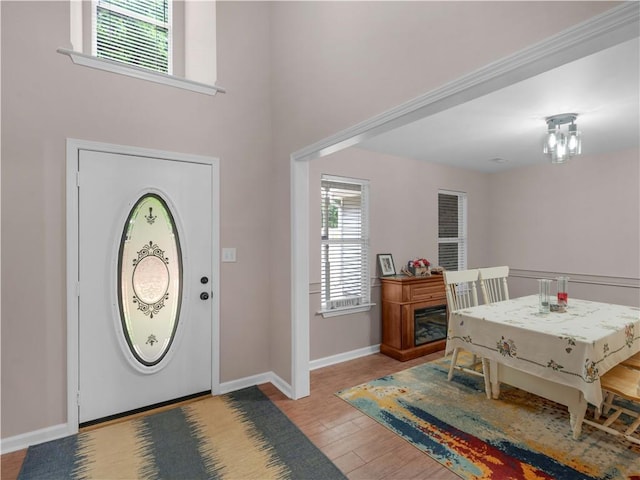 entryway with baseboards and wood finished floors