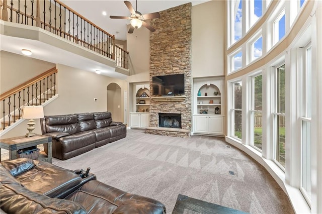 412 Mill Stream Way, Woodstock, GA 30188 - living area featuring a towering ceiling, plenty of natural light, a ceiling fan, built in shelves, and stairs