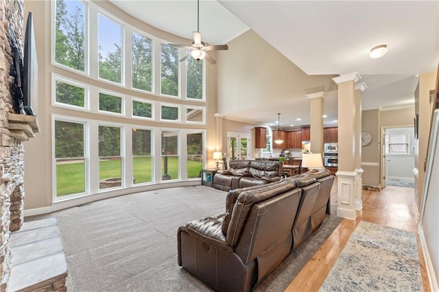 412 Mill Stream Way, Woodstock, GA 30188 - living room featuring decorative columns, ceiling fan, light wood finished floors, crown molding, and baseboards