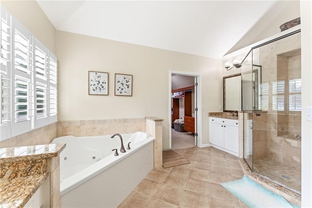 412 Mill Stream Way, Woodstock, GA 30188 - full bathroom with vaulted ceiling, vanity, a whirlpool tub, a shower stall, and tile patterned flooring