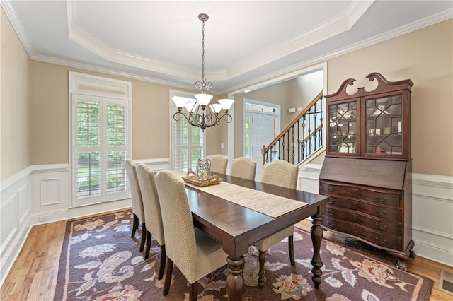 412 Mill Stream Way, Woodstock, GA 30188 - dining space featuring a chandelier, wood finished floors, a tray ceiling, a wainscoted wall, and ornamental molding