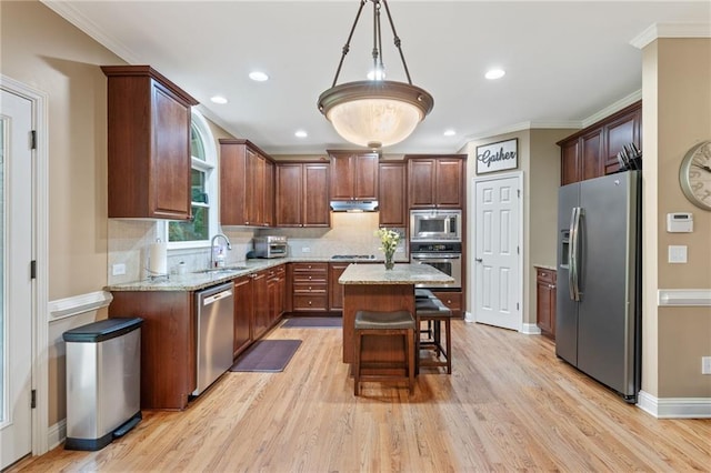 412 Mill Stream Way, Woodstock, GA 30188 - kitchen with appliances with stainless steel finishes, a sink, light wood-style floors, a center island, and crown molding