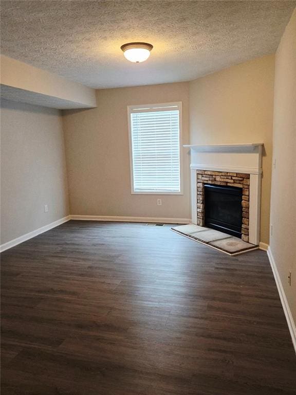 204 Twin Pines Ct, Dallas, GA 30132 - unfurnished living room with wood finished floors, a fireplace, baseboards, and a textured ceiling