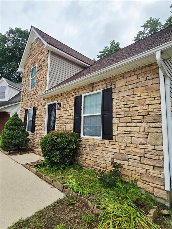 204 Twin Pines Ct, Dallas, GA 30132 - view of side of property with stone siding and roof with shingles